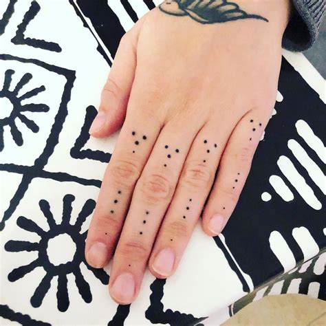 Black dots on fingers tattoo meaning  In a general sense, one can say that it symbolizes the downsides of being in prison